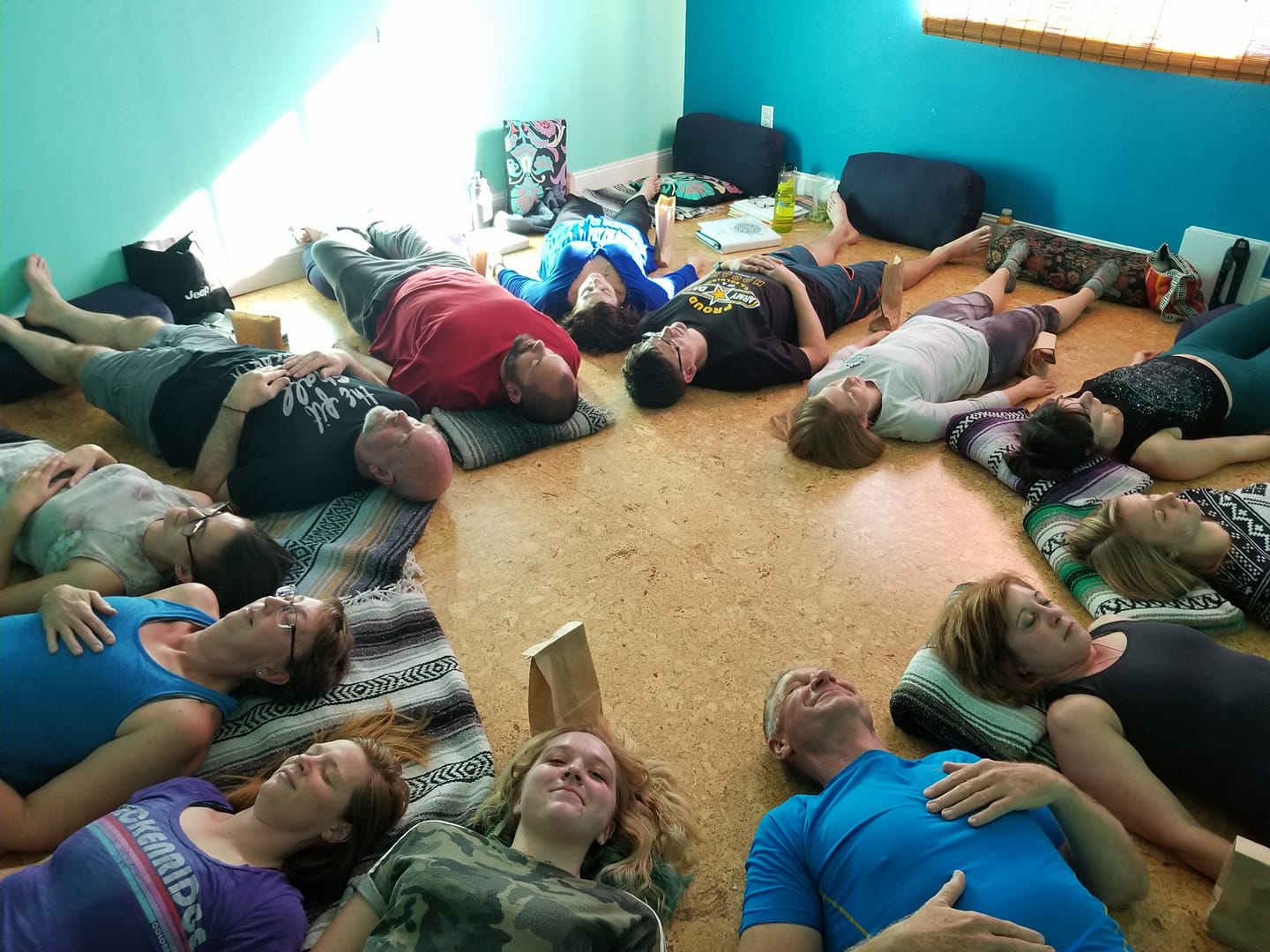 Group of students laying with heads facing middle in a circle