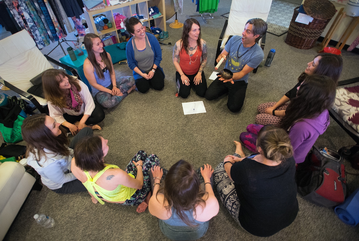 people sitting in yoga studio in a circle